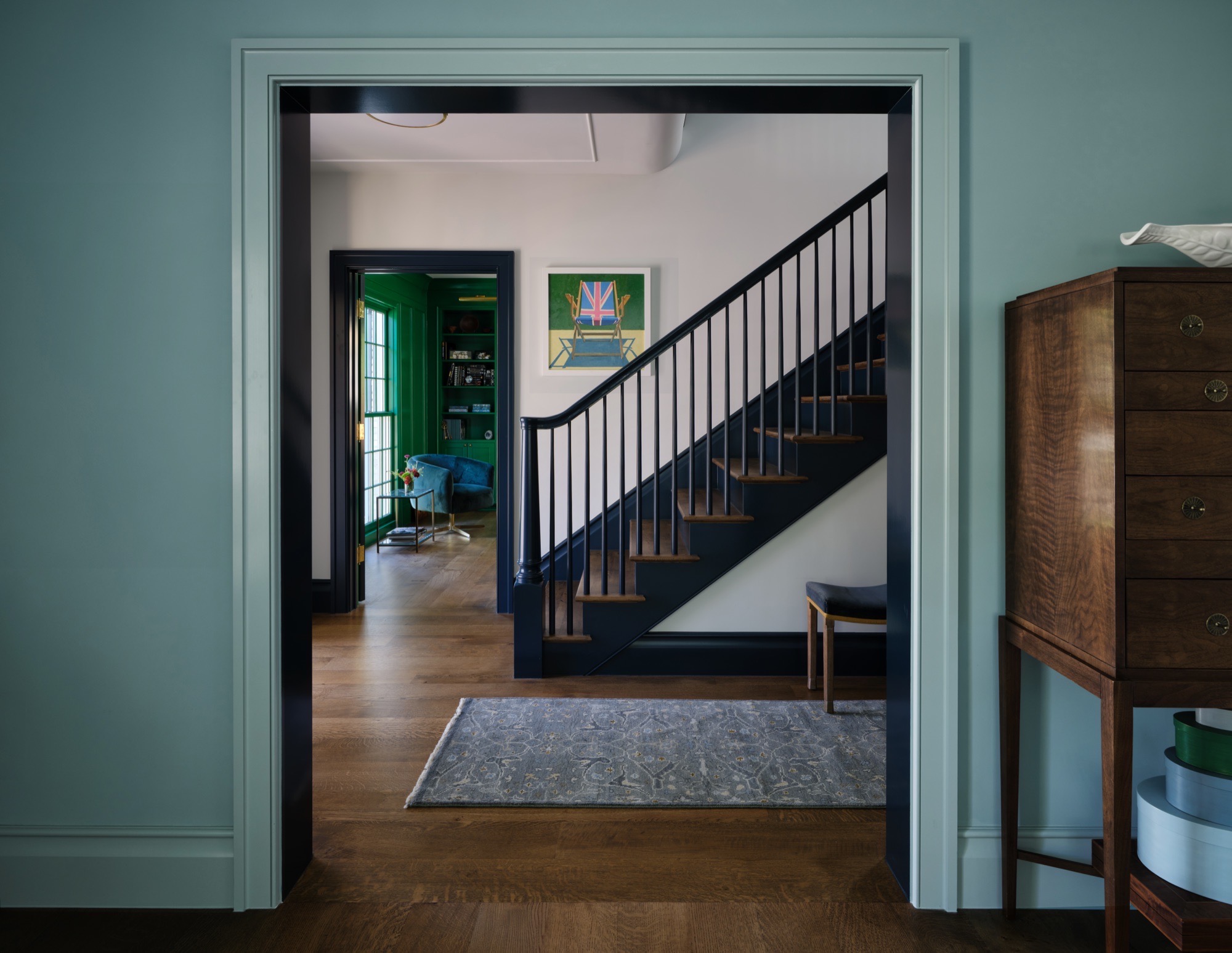 Paneled stair hall in a rehabilitated circa-1936 Colonial Revival house in Austin