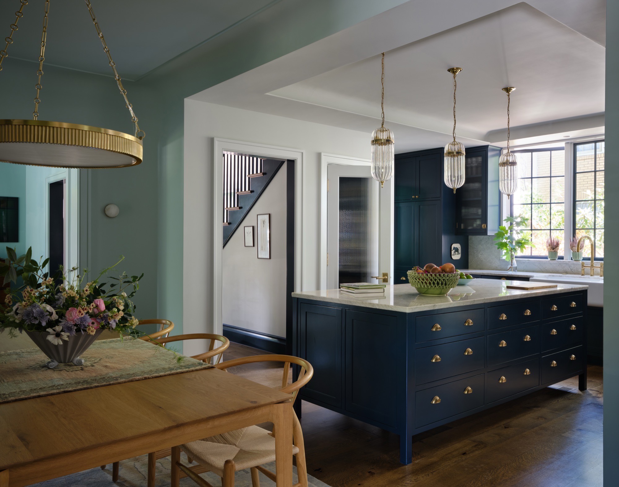 Connected kitchen and dining room in a rehabilitated Colonial Revival house in Austin