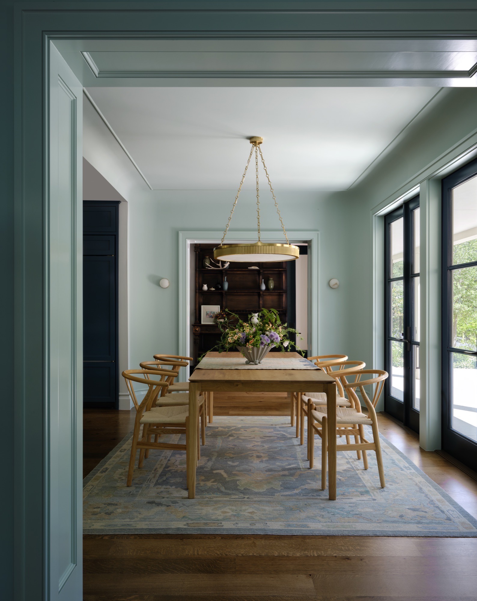 Dining room with painted trim and black French doors in an Austin Colonial Revival house