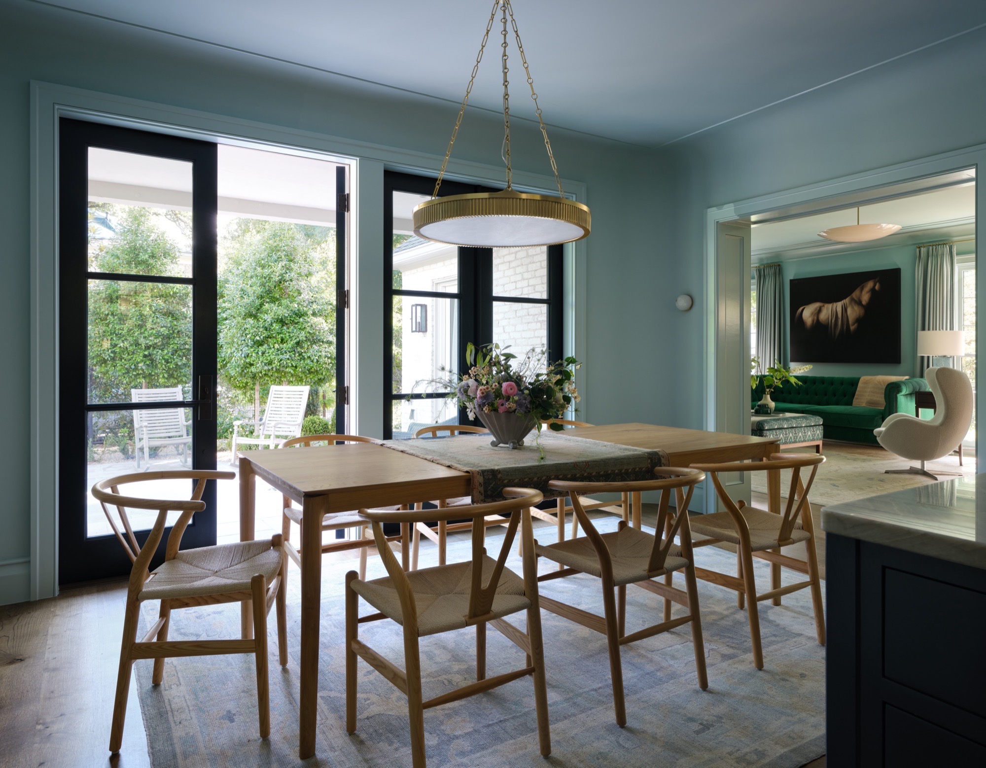 Dining room opening to the living room and garden in an Austin historic rehabilitation