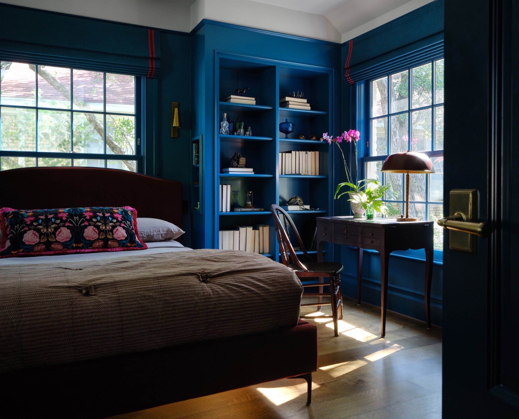 Deep blue bedroom with built-in shelves in a circa-1936 Austin house
