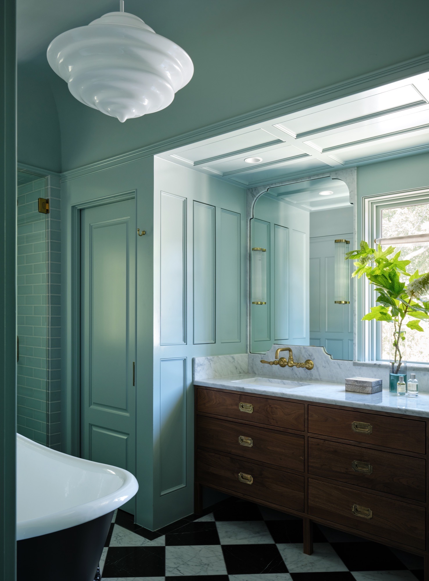 Paneled bathroom with walnut vanity and checkerboard marble floor in Austin