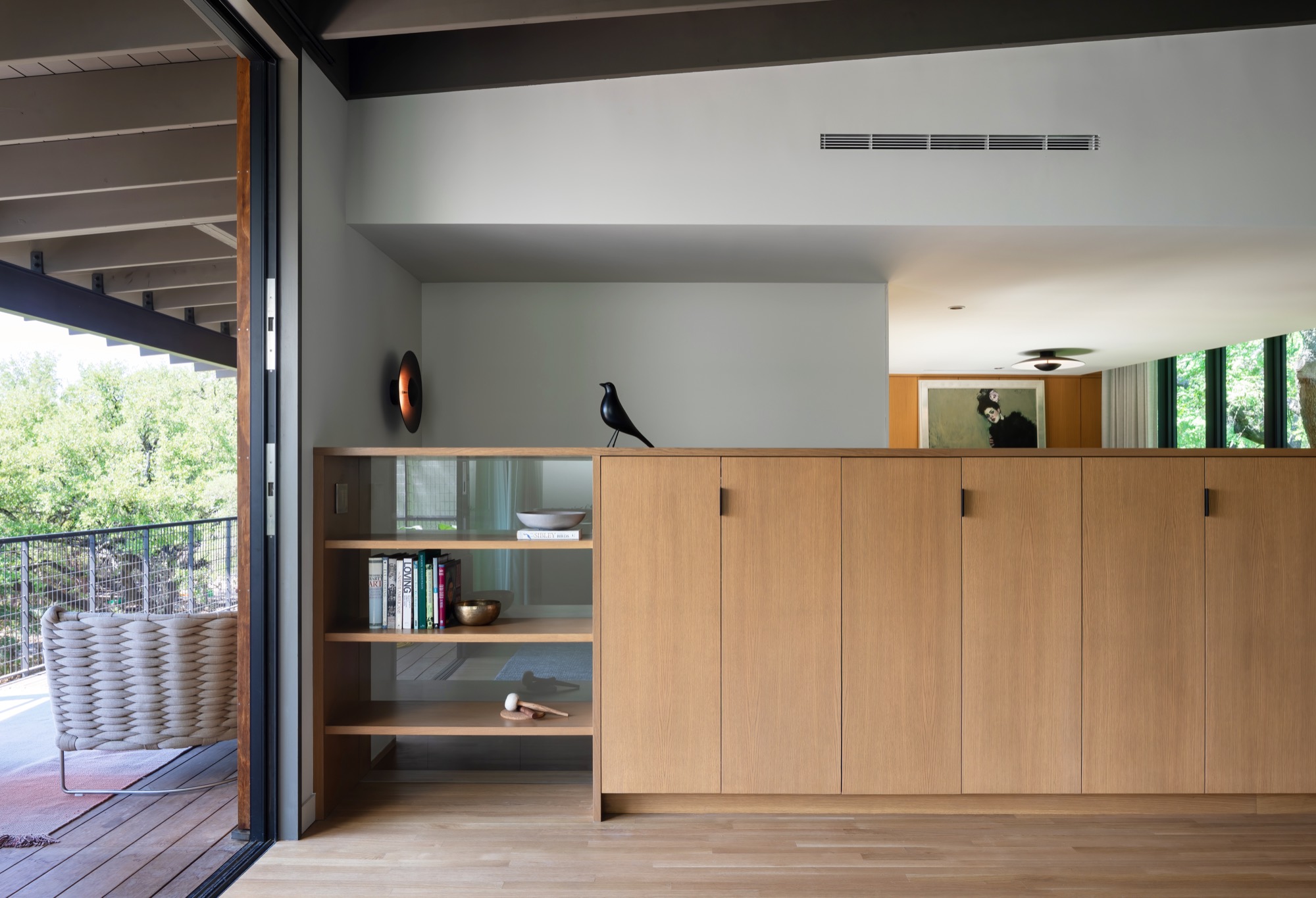 Low TV cabinet integrated with the stair wall in a modern Austin house