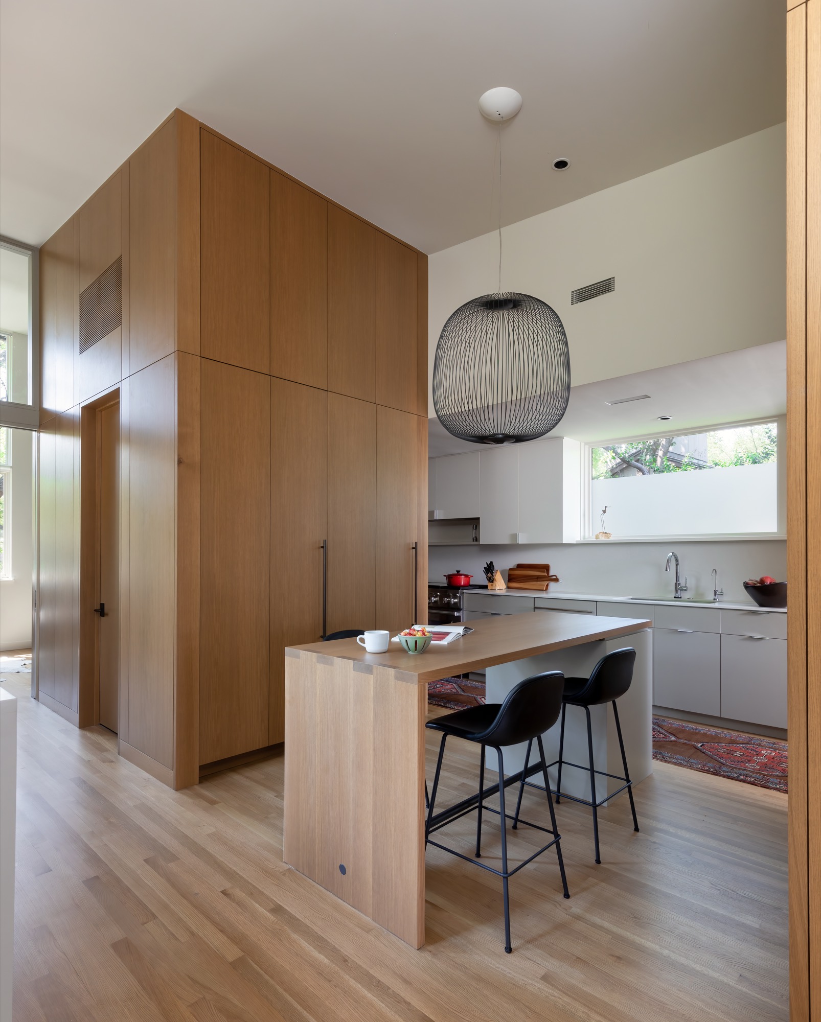 Kitchen of a modern Austin house with a wood island and pendant light
