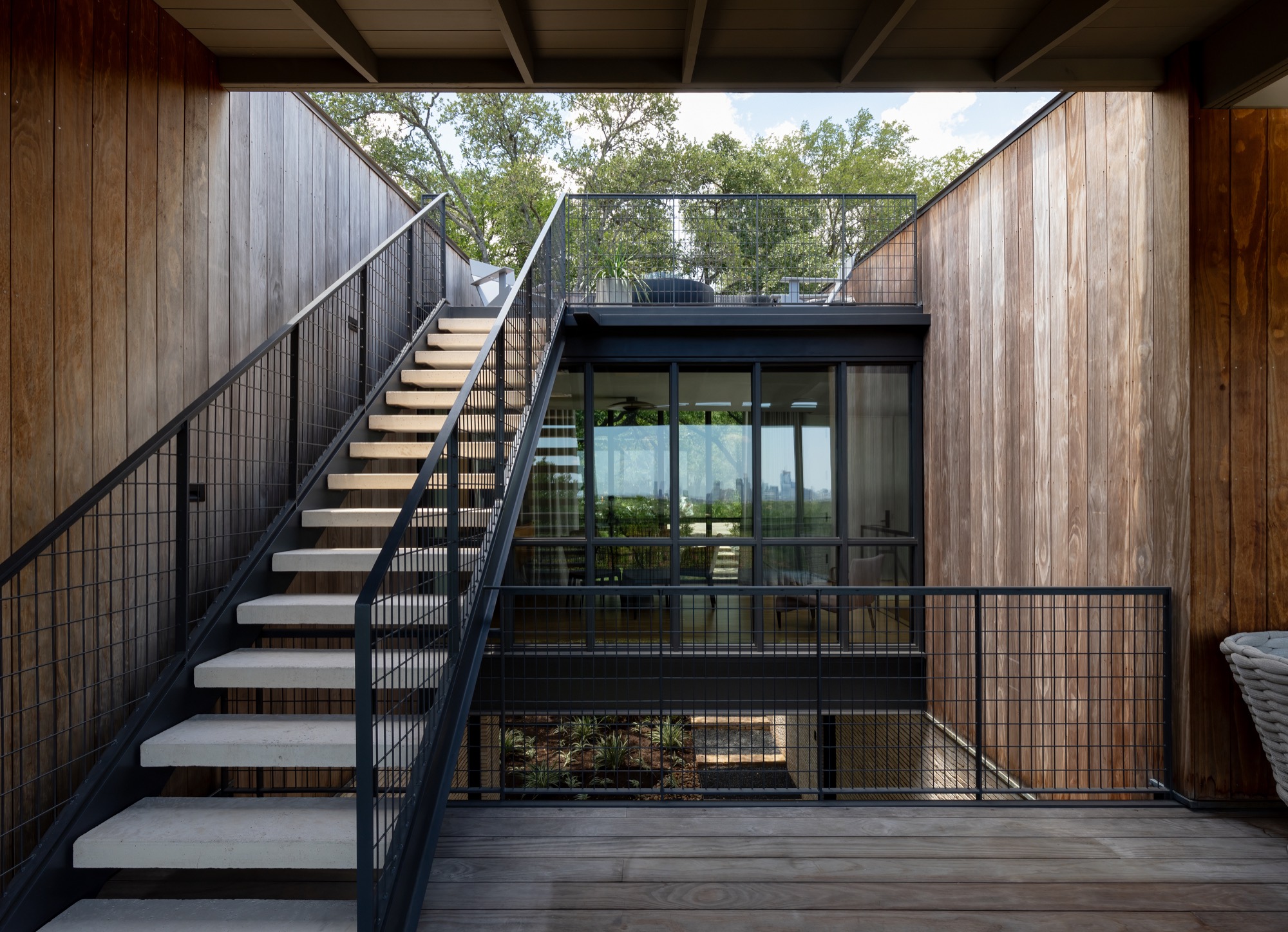 Stair to the roof terrace above the breezeway of a modern Austin house