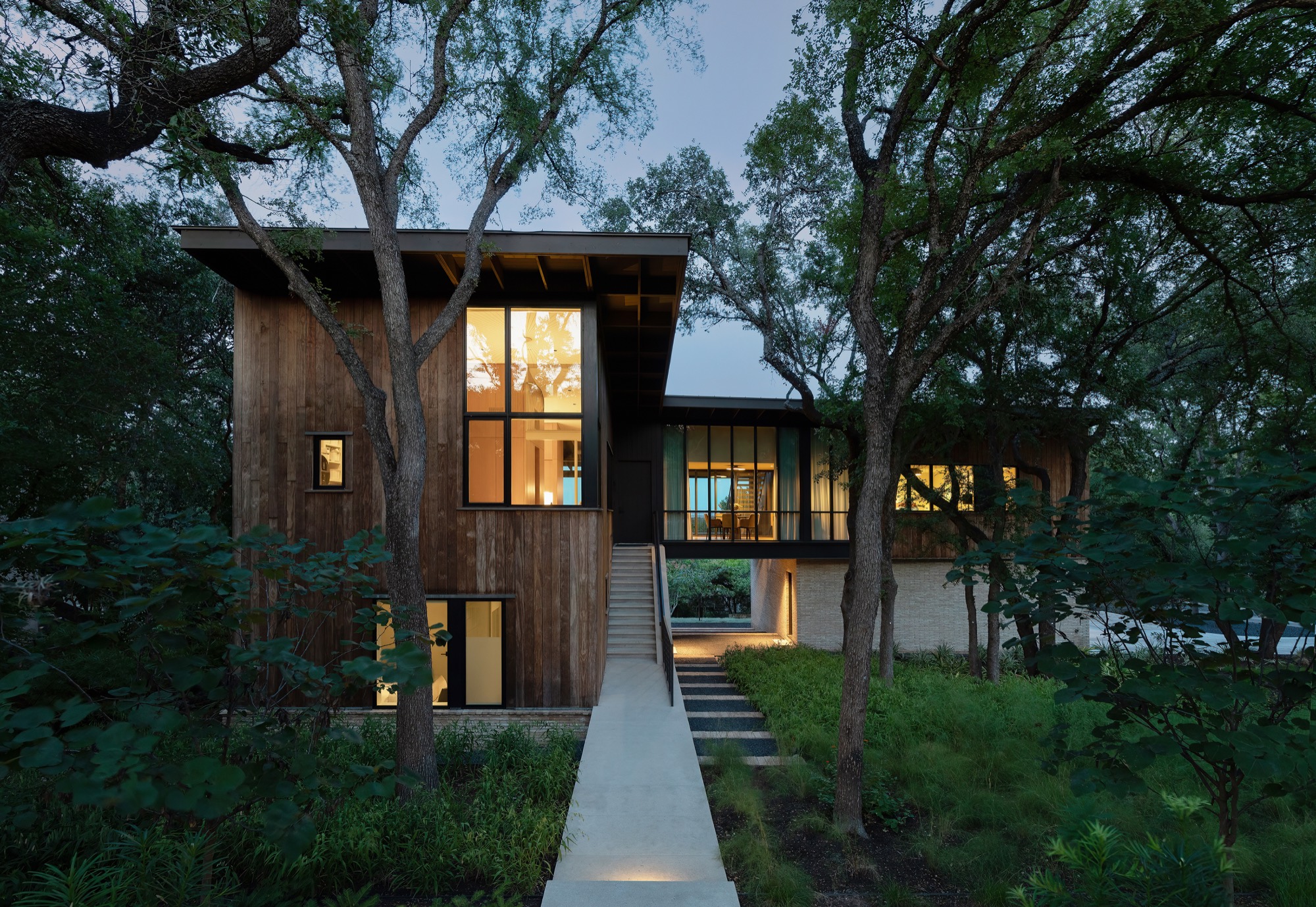 Modern custom home in West Lake Hills Austin Texas with wood facade and dormer entry